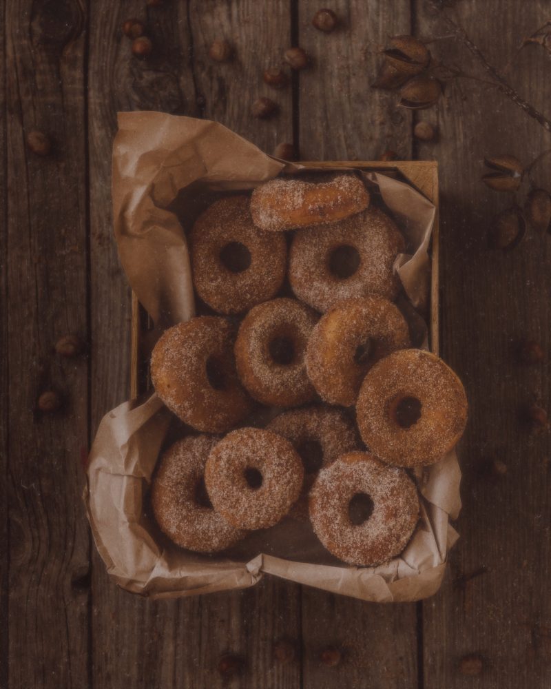 a basket of cinnamon sugar doughnuts on a wooden table