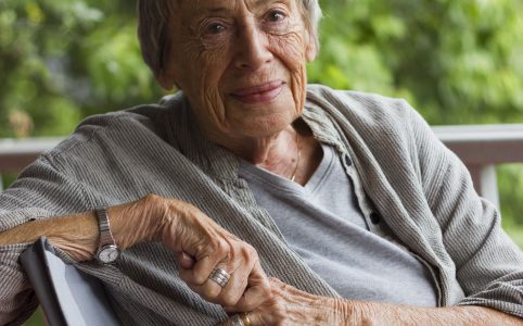 Ursula K. Le Guin seated and turned toward the camera with a peaceful smile