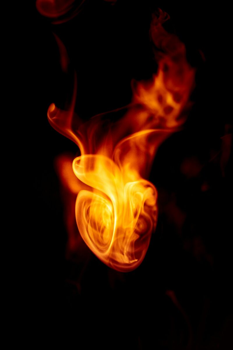 flame in the shape of a heart against a dark background